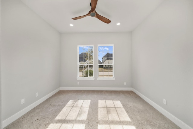 unfurnished room with ceiling fan and light colored carpet