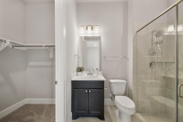 bathroom with vanity, toilet, and walk in shower