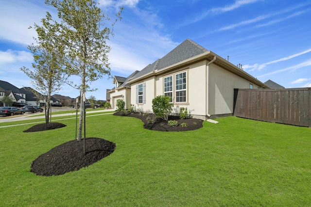 view of side of property with a yard