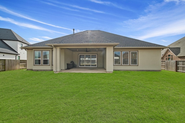 back of house with a yard, a patio, and ceiling fan