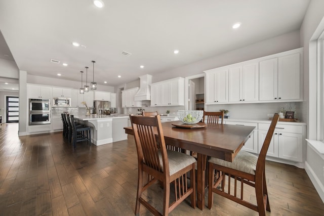 dining space featuring dark wood-type flooring