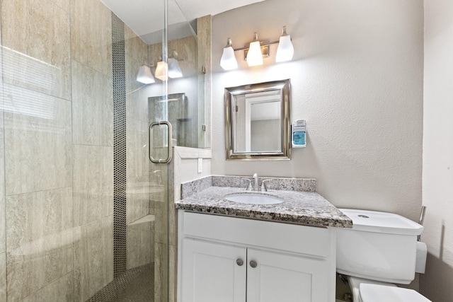 bathroom featuring vanity, toilet, and an enclosed shower