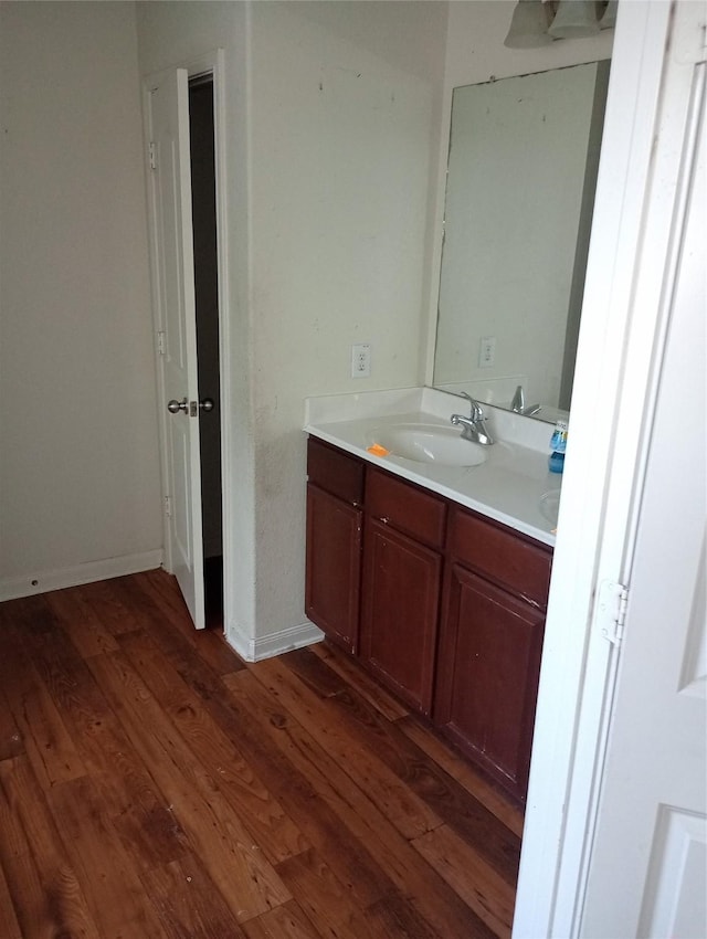 bathroom with vanity and hardwood / wood-style floors