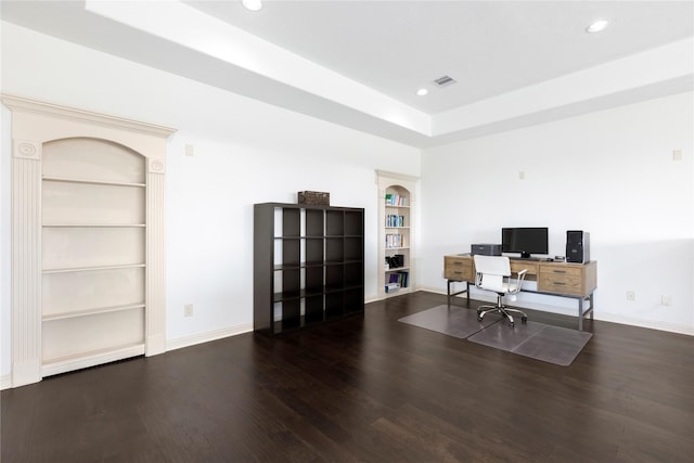 office area with built in shelves and dark hardwood / wood-style floors