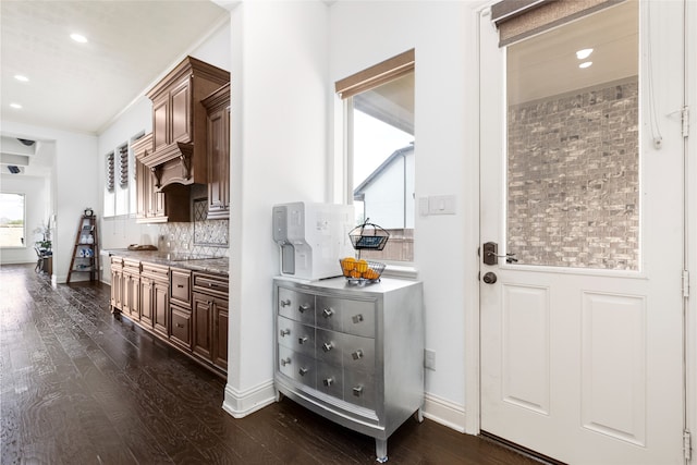 kitchen featuring dark hardwood / wood-style floors and backsplash