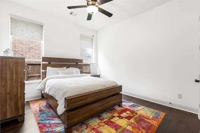 bedroom with ceiling fan and dark hardwood / wood-style flooring