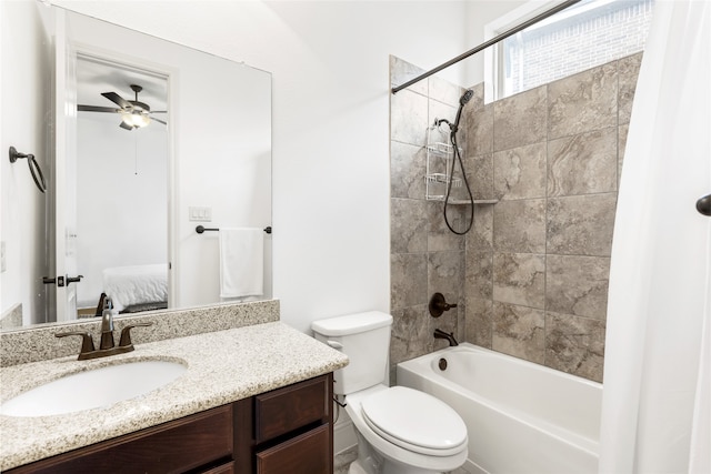 full bathroom with vanity, ceiling fan, toilet, and tiled shower / bath