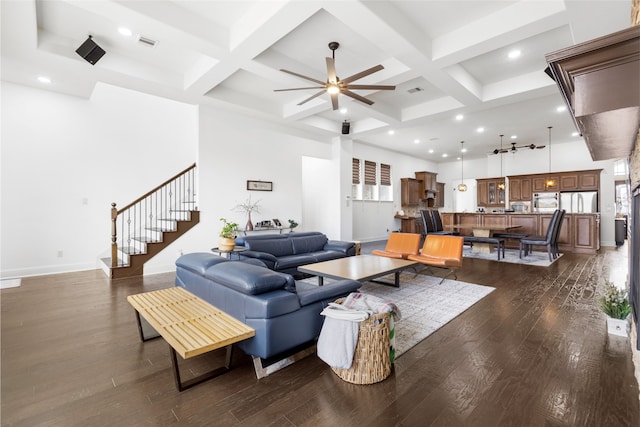 living room featuring coffered ceiling, a towering ceiling, dark hardwood / wood-style floors, and beam ceiling