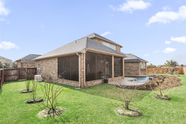 back of property with a yard and a sunroom