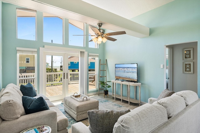 living room featuring hardwood / wood-style flooring, ceiling fan, and french doors