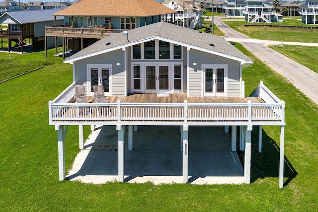 back of property with french doors, a balcony, a deck, and a patio