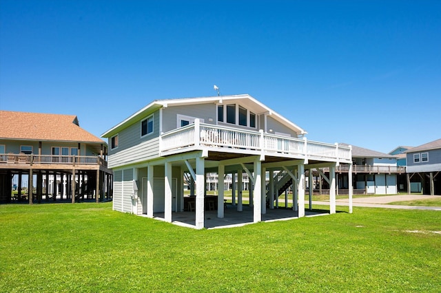 back of property featuring a wooden deck and a lawn