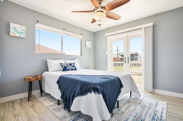 bedroom with ceiling fan, access to exterior, and light hardwood / wood-style floors