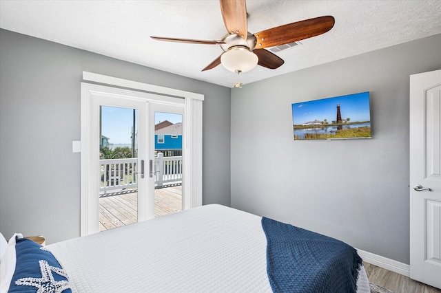 bedroom featuring wood-type flooring, access to exterior, ceiling fan, a textured ceiling, and french doors