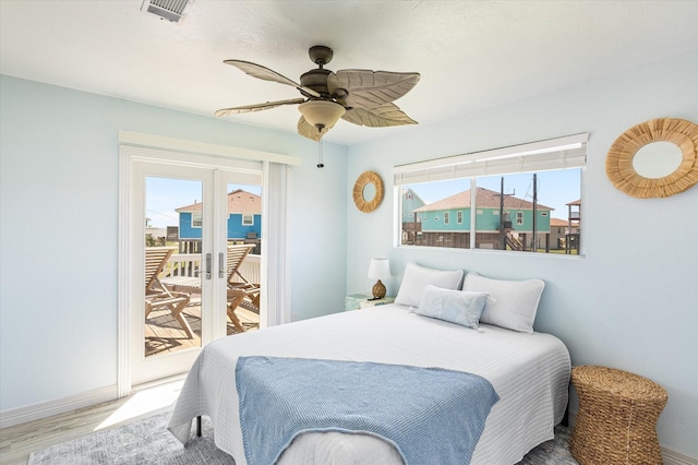 bedroom with light hardwood / wood-style flooring, access to outside, and ceiling fan