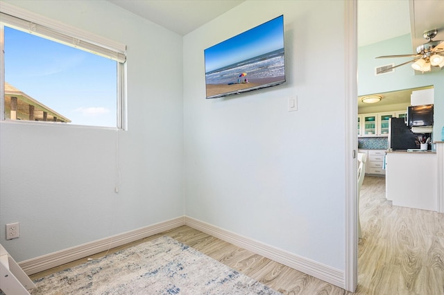 empty room featuring ceiling fan and light hardwood / wood-style floors