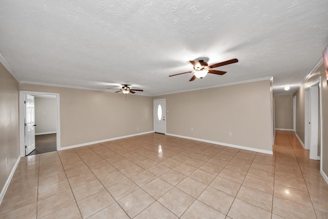 tiled spare room featuring ceiling fan, ornamental molding, and a textured ceiling