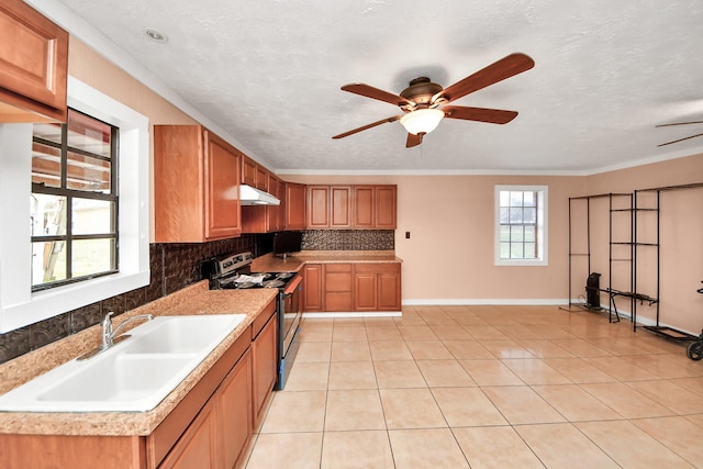 kitchen featuring sink, tasteful backsplash, stainless steel range with electric stovetop, a textured ceiling, and light tile patterned floors