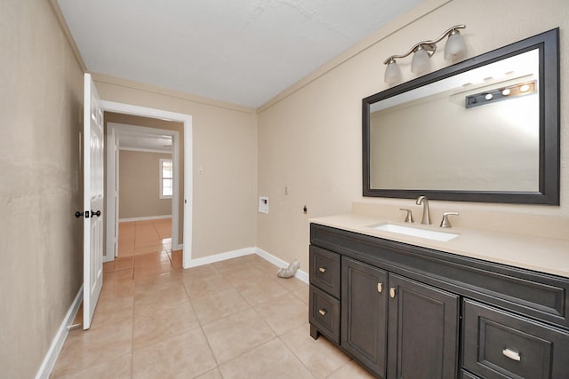 bathroom with ornamental molding, tile patterned flooring, and vanity