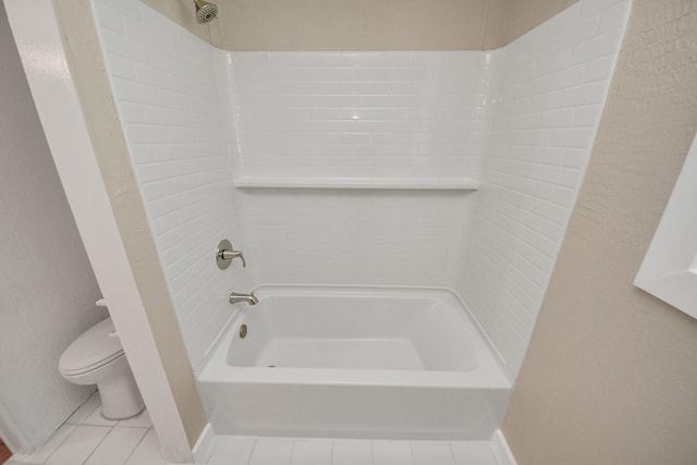 bathroom featuring tile patterned flooring, tub / shower combination, and toilet