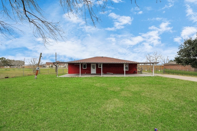 rear view of property with a yard