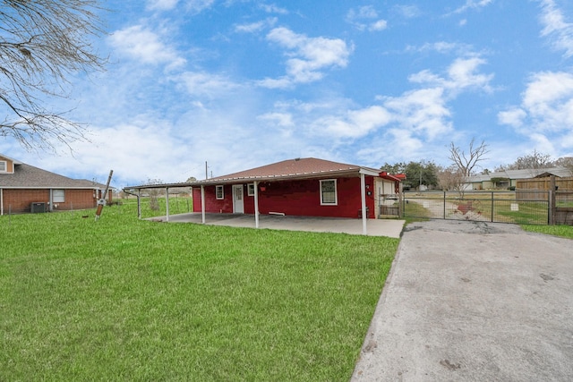 rear view of property featuring cooling unit, a yard, and a patio area