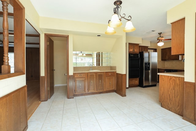 kitchen featuring ceiling fan with notable chandelier, pendant lighting, sink, decorative backsplash, and stainless steel refrigerator with ice dispenser