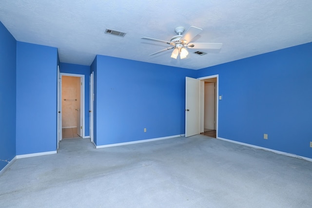 unfurnished bedroom featuring ceiling fan, carpet flooring, and a textured ceiling