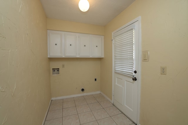 clothes washing area featuring electric dryer hookup, cabinets, washer hookup, a textured ceiling, and light tile patterned flooring