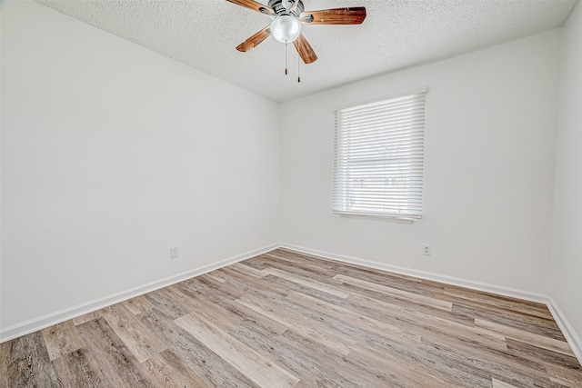 spare room featuring ceiling fan, light hardwood / wood-style floors, and a textured ceiling