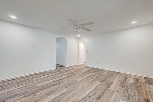 empty room with ceiling fan and light hardwood / wood-style flooring