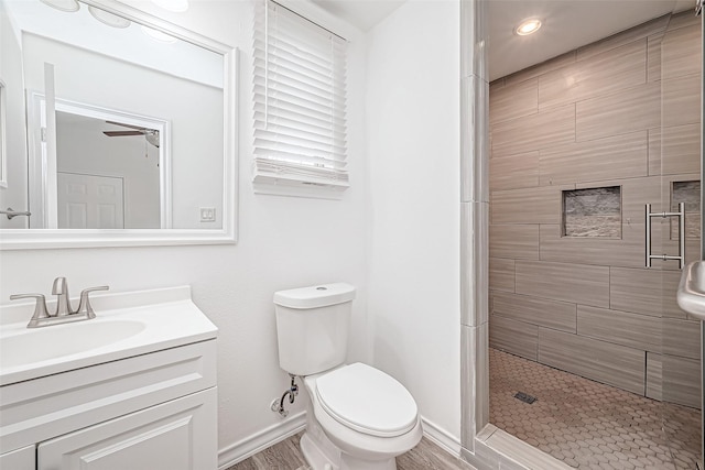 bathroom with vanity, hardwood / wood-style floors, toilet, and walk in shower