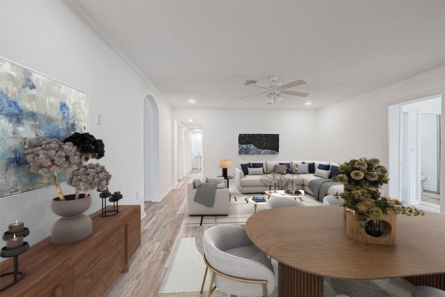 dining space with ornamental molding, ceiling fan, and light hardwood / wood-style flooring