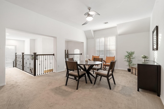 dining space featuring light colored carpet and ceiling fan