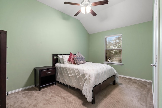 carpeted bedroom with vaulted ceiling and ceiling fan