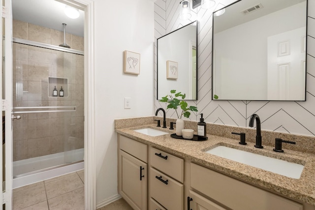 bathroom with tile patterned floors, vanity, and a shower with door