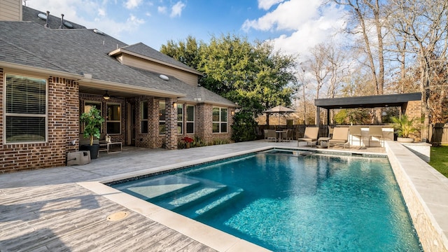 view of pool with a patio and ceiling fan