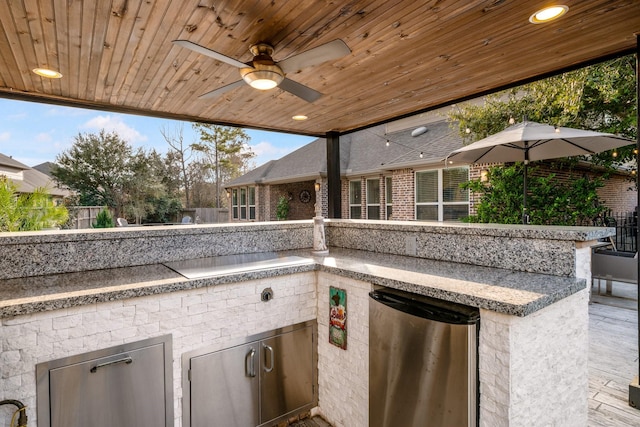 view of patio featuring ceiling fan and exterior kitchen