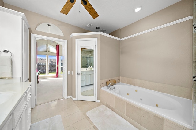 bathroom featuring ceiling fan, tile patterned floors, vanity, and tiled bath