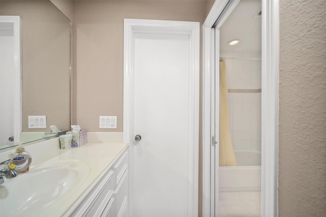 bathroom with shower / tub combo with curtain and vanity