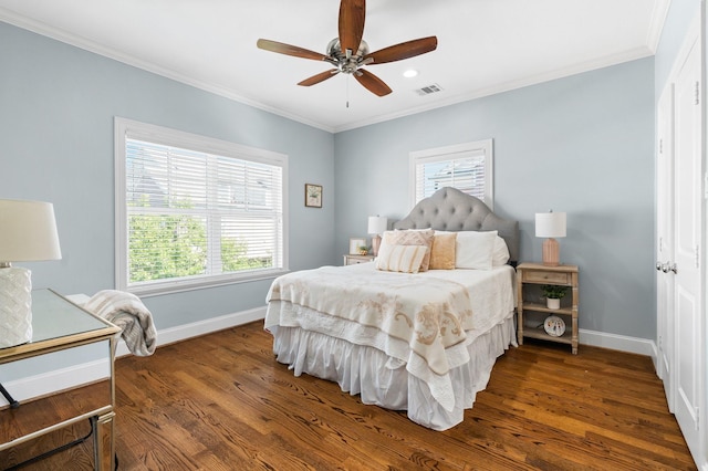 bedroom with multiple windows, dark hardwood / wood-style flooring, and ornamental molding