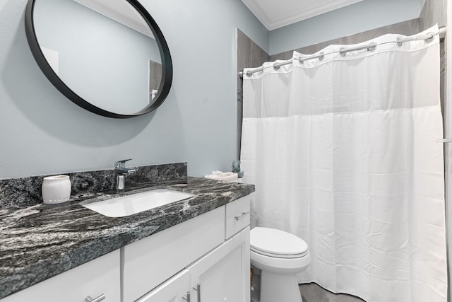 bathroom with vanity, crown molding, and toilet