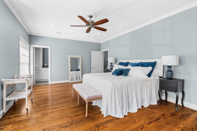 bedroom with hardwood / wood-style flooring, ceiling fan, ornamental molding, and connected bathroom