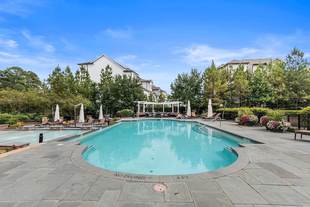 view of swimming pool featuring a pergola and a patio area