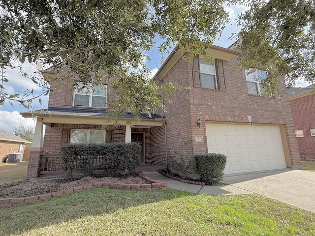 traditional-style house featuring central AC, brick siding, a front yard, and driveway