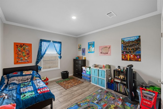 bedroom featuring ornamental molding and light hardwood / wood-style floors