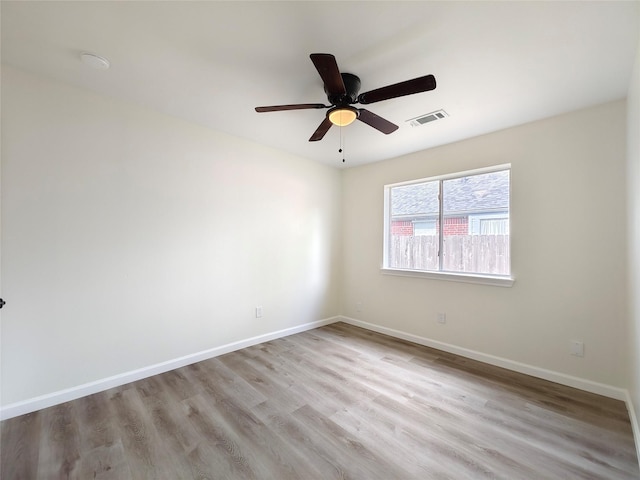 spare room featuring ceiling fan and light hardwood / wood-style flooring