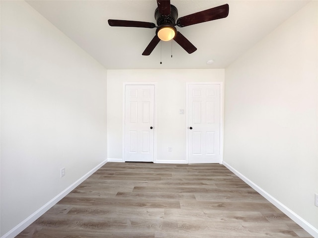 unfurnished bedroom with light hardwood / wood-style floors and ceiling fan