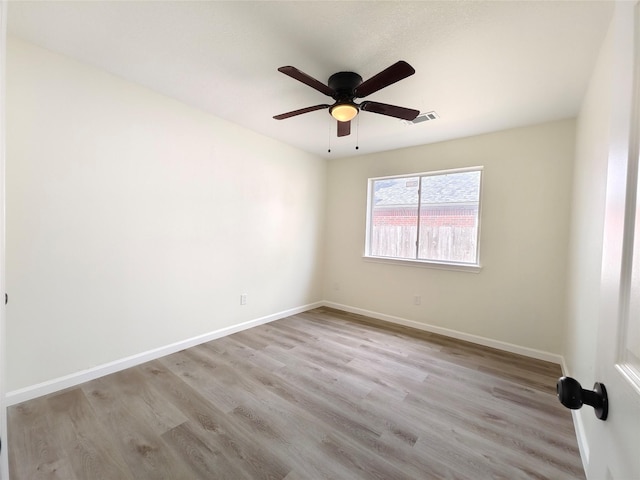 empty room with ceiling fan and light hardwood / wood-style floors