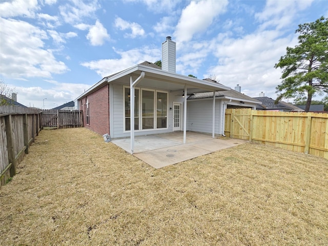 rear view of house featuring a yard, a patio, and ceiling fan